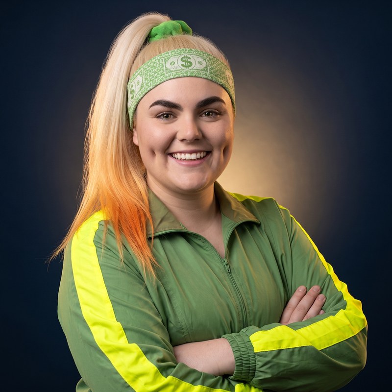 Portrait of Donna Dollars, smiling confidently with a signature headband.